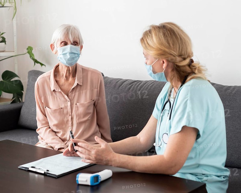 Nurse elder woman conversing nursing home