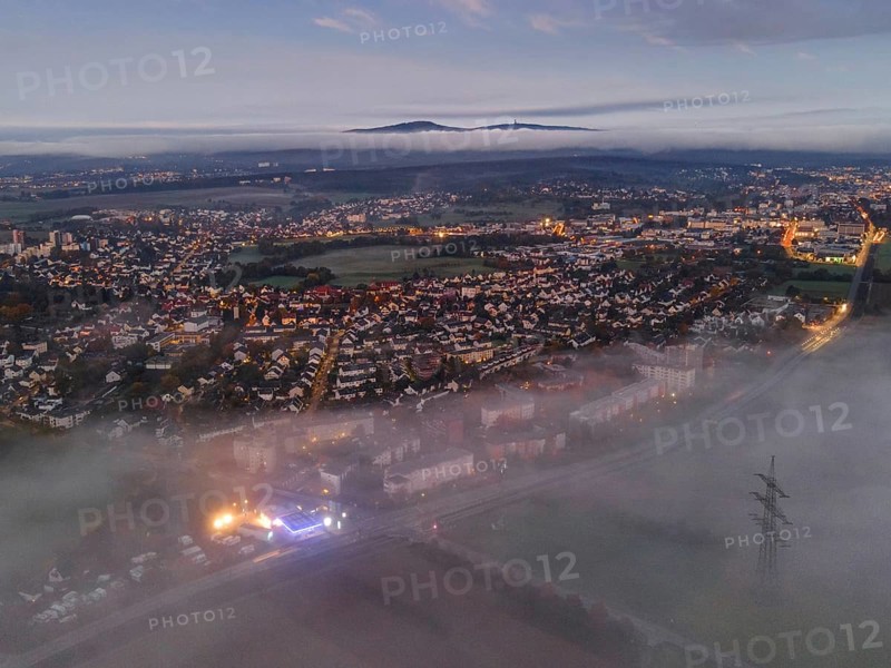 Fog rolls in over the Oberursel district of Weißkirchen, near Frankfurt am Main, in the morning, while the Taunus ridge with the Großer Feldberg and the Altkönig protrude from the clouds on the horizon. (Aerial view with a drone), Weißkirchen, Hesse, Germany, Europe