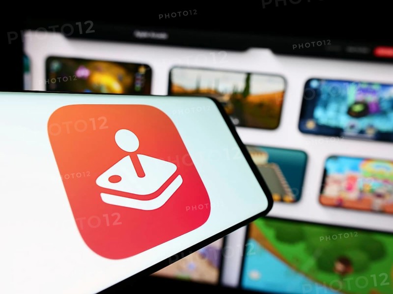 Stuttgart, Germany, 09-23-2023: Cellphone with logo of video game platform Apple Arcade on screen in front of company website. Focus on center of phone display, Europe