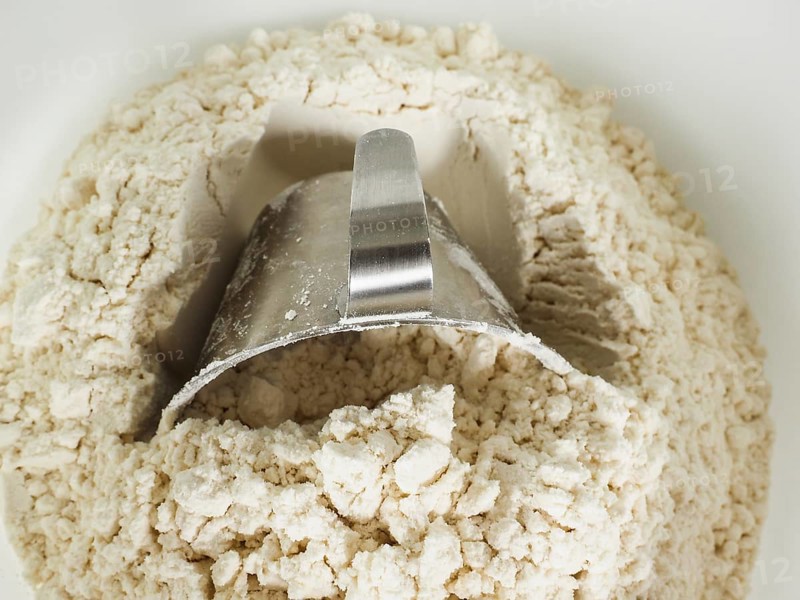 Measurement tool in a bowl of wheat flour