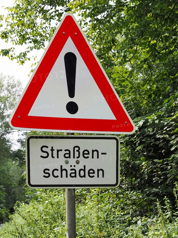 Traffic sign Attention with road damage, North Rhine-Westphalia, Germany, Europe