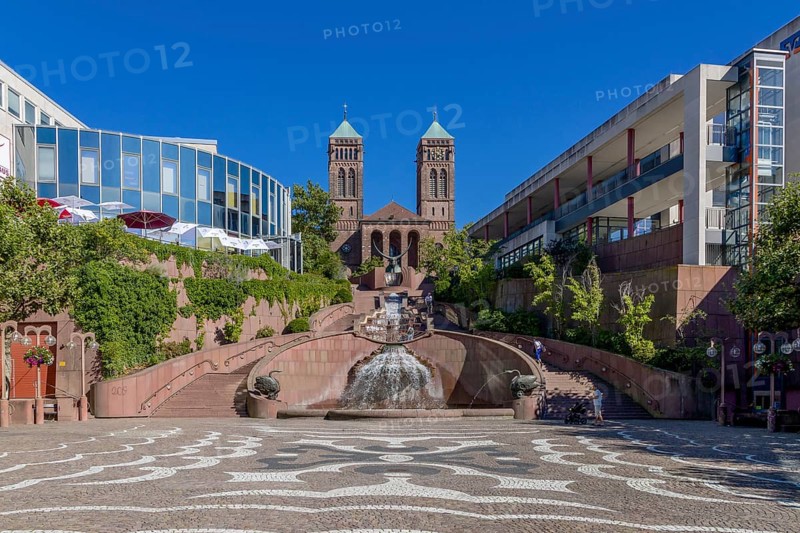 The town's landmark is the castle fountain (sculptor Gernot Rumpf) with its castle steps on Schlossplatz square in the pedestrian zone and the towers of St Pirmin's Catholic Church in the background, Pirmasens, Rhineland-Palatinate, Germany, Europe