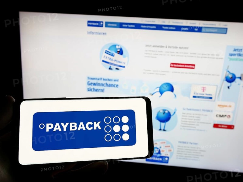 Stuttgart, Germany, 09-01-2023: Person holding smartphone with logo of German loyalty management company Payback GmbH on screen in front of website. Focus on phone display, Europe