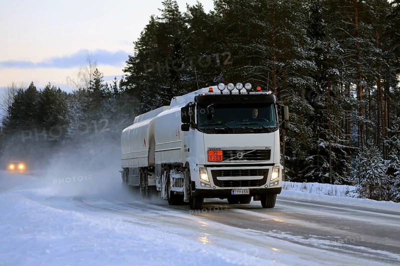Volvo FH tanker truck transports gasoline, ADR 33-1203, on snowy highway on a winter afternoon. Salo, Finland. January 18, 2019