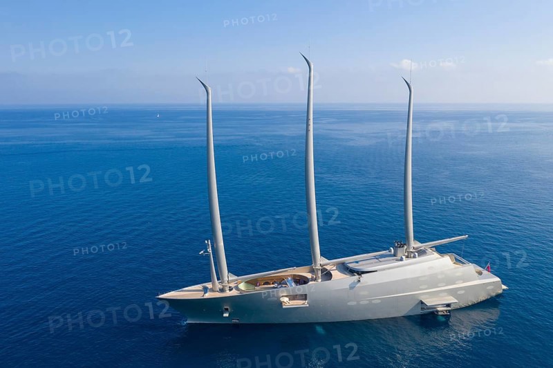 Aerial view 143 metre long three-master Sailing Yacht A, the largest sailing yacht in the world, built to a design by designer Philippe Starck by the German shipyard Nobiskrug and delivered in 2017 to the Russian oligarch Andrei Melnichenko, Andrey Melnichenko, over 100 metre high carbon masts, at anchor off Menton, Cote d'Azur, Mediterranean Sea
