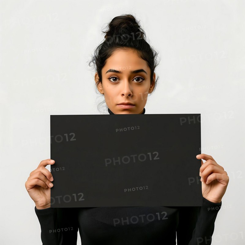 Young woman with a sceptical look, dark pinned-up hairdo, holding up a notice board, advertisement, sign, display board, special offer, price reduction, price increase, cost explosion, cost increase, rent increase, action, AI generated