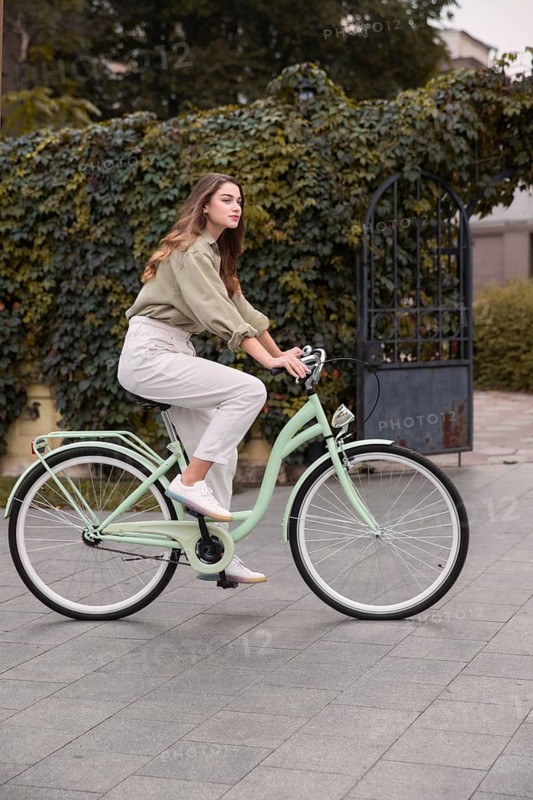 Side view woman city riding bicycle