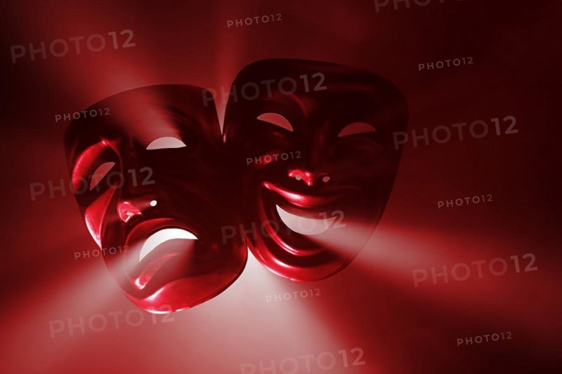 Crying and smiling masks in hazy light