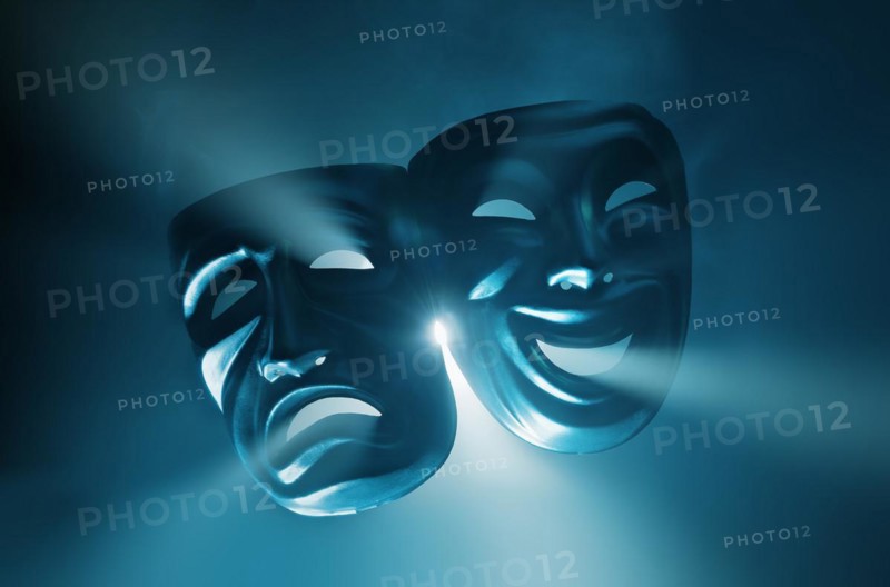 Crying and smiling masks in hazy light