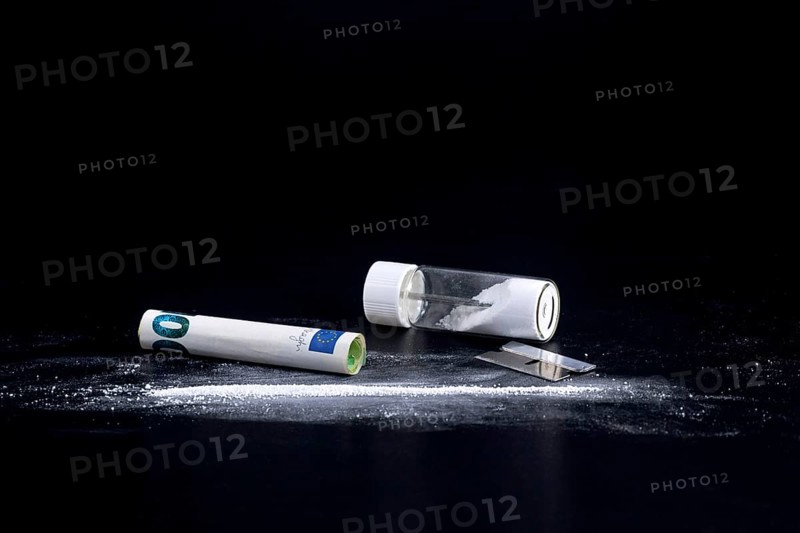 Cocaine Line and Razor Blade on a Black Background