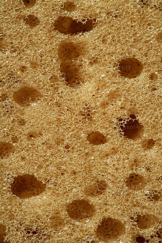 Orange sponge texture background, macro detail of surface