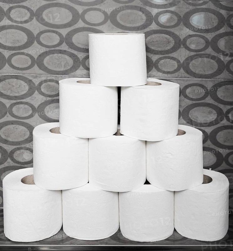 Close up stack toilet paper rolls shelf