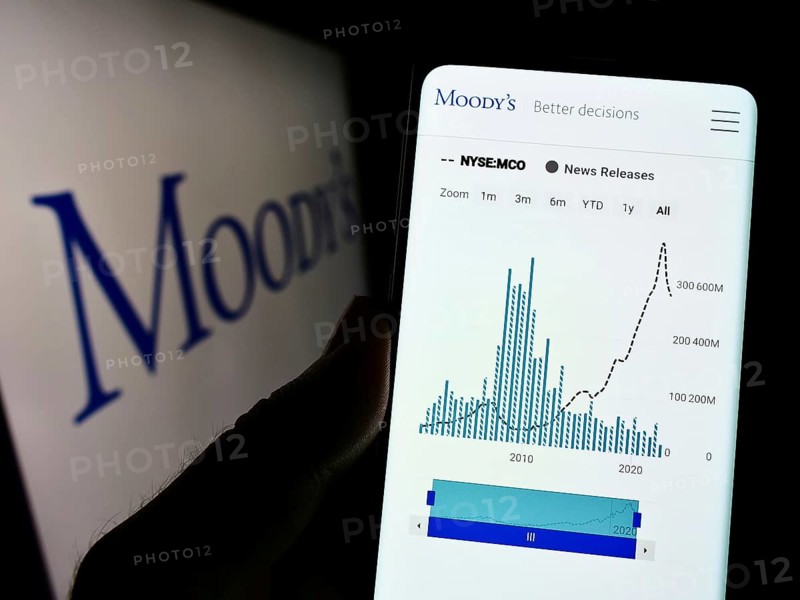 Stuttgart, Germany, 10-09-2022: Person holding smartphone with webpage of rating company Moody's Investors Service Inc. on screen with logo. Focus on center of phone display, Europe