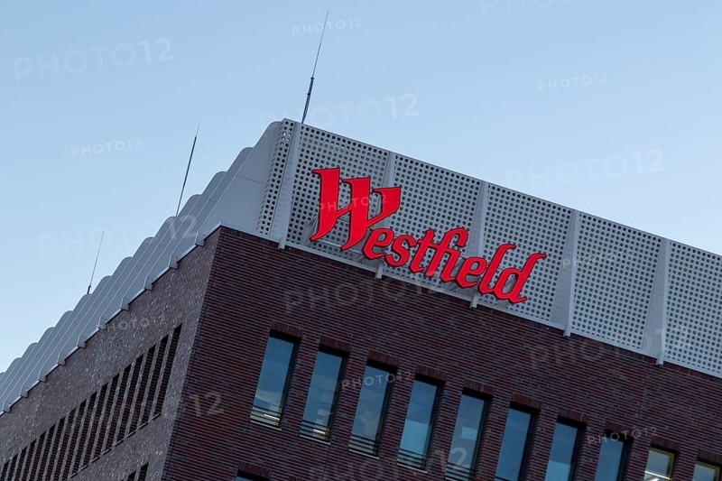 Logo, lettering on the construction site of the Westfield Hamburg-Überseequartier shopping centre, which was severely delayed in its opening date due to construction defects, in the evening light, Hafencity, Hamburg, Germany, Europe