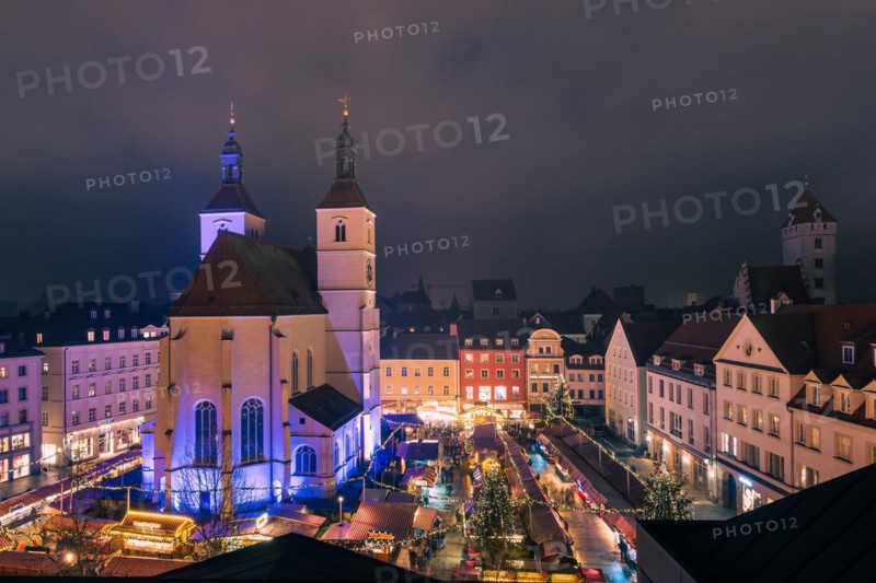 The traditional famous Christmas market on the Neupfarrplatz in Regensburg in December seen from roof terrace at night