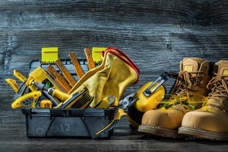 Big set of construction tools in little toolbox and boots
