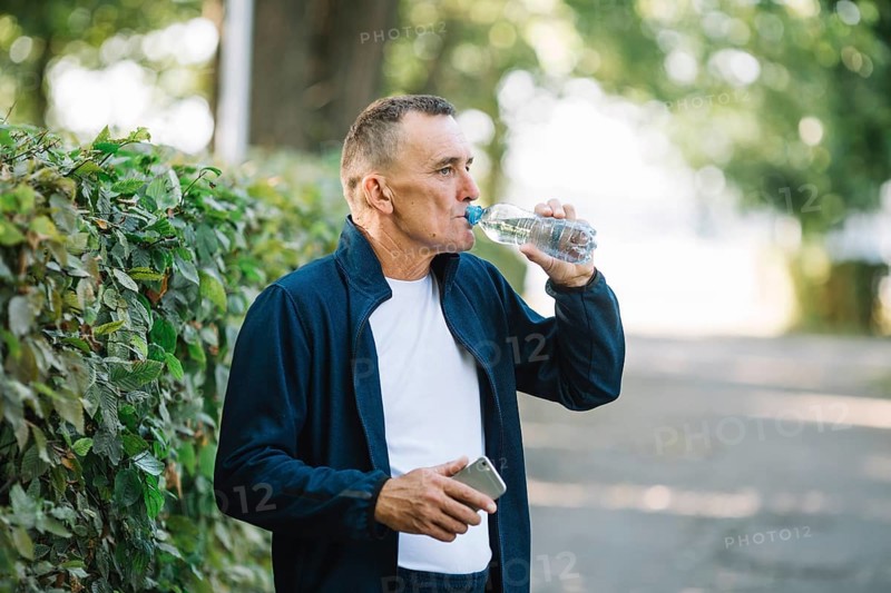 Old man drinking water park