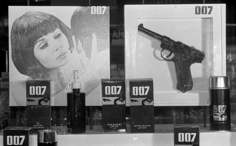 With the advertising fad James Bond 007, here in the Ruhr area in 1966 in department stores and drugstores, catching customers and partly with Bond (toy) pistol in hand, Germany, Europe