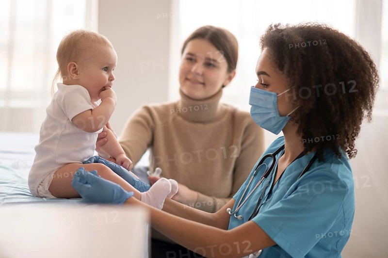Little baby being health clinic vaccination