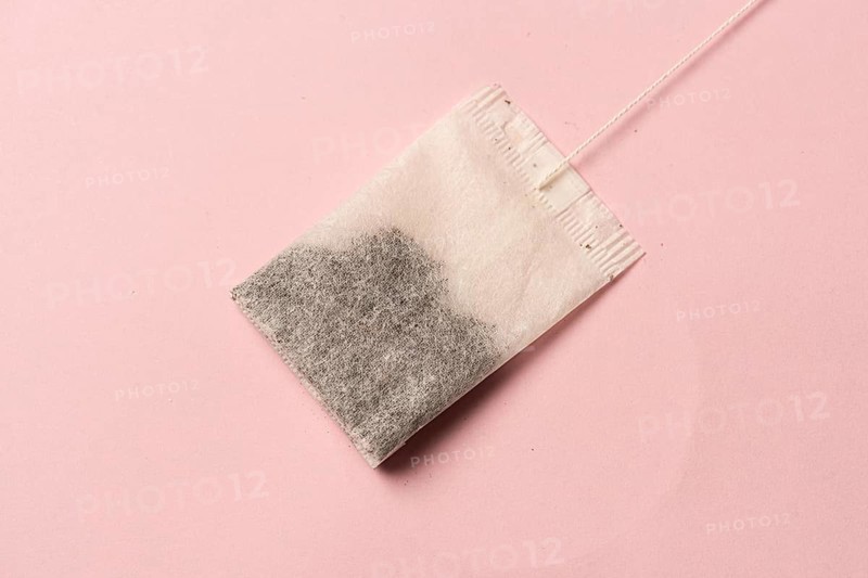 Tea bag on pink background