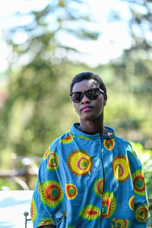 Young adult afro hair diverse black model pose outdoors in african print attire wear sunglasses
