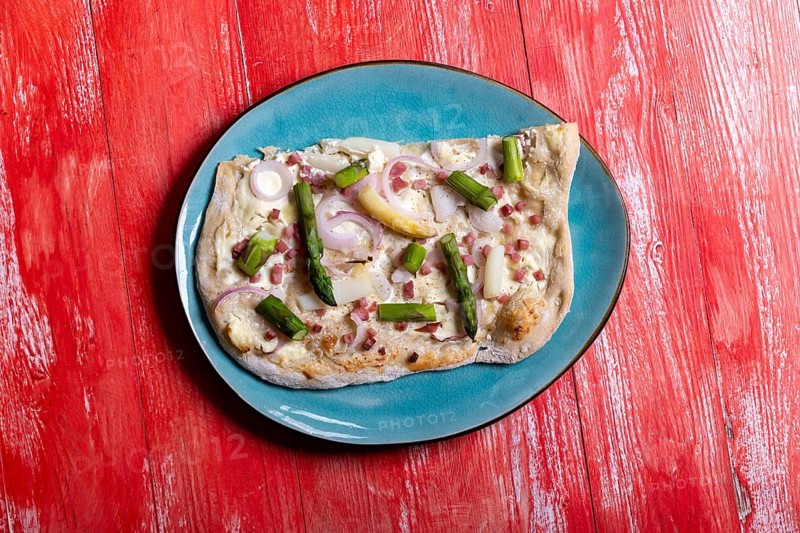 French tarte flambee on red wood