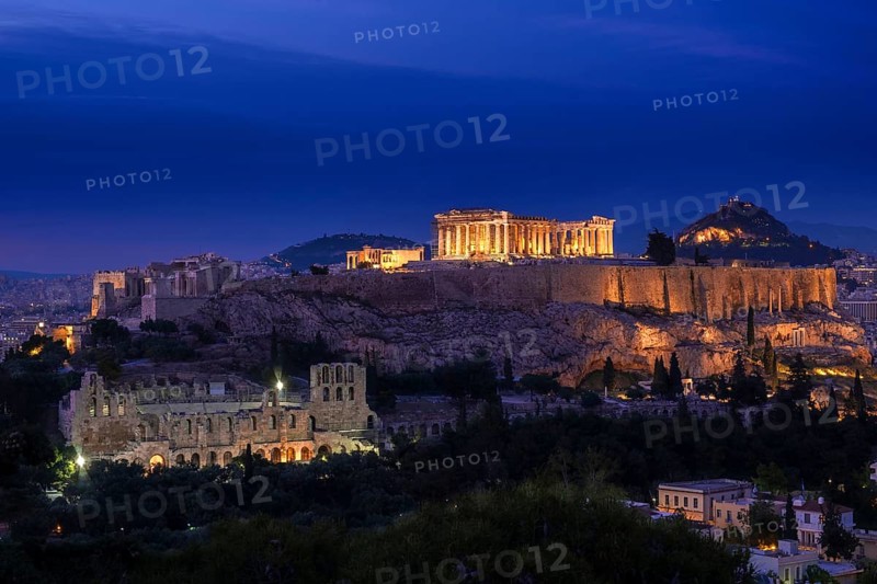 Iconic view of Acropolis hill in Athens, Greece at night. Delicate lights of Parthenon and Odeon theater. UNESCO world heritage. Classic architecture, majestic antiquity