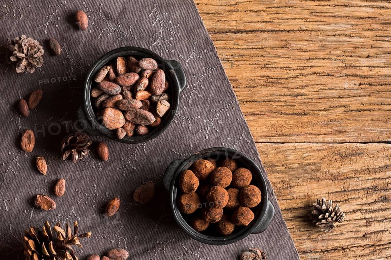 Top view cocoa beans chocolate truffles bowls
