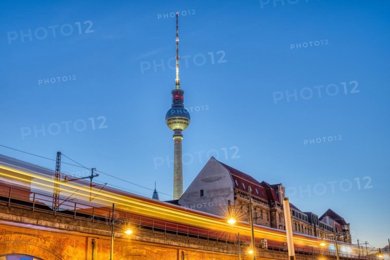 The famous TV tower in Berlin at dusk with a motionless S-Bahn train