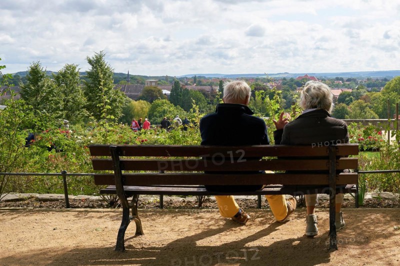 Elderly pensioner couple sitting on a bench and enjoying the view