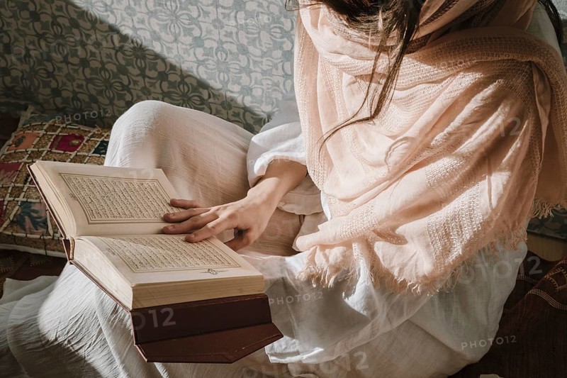 Sitting woman reading quran. Resolution and high quality beautiful photo