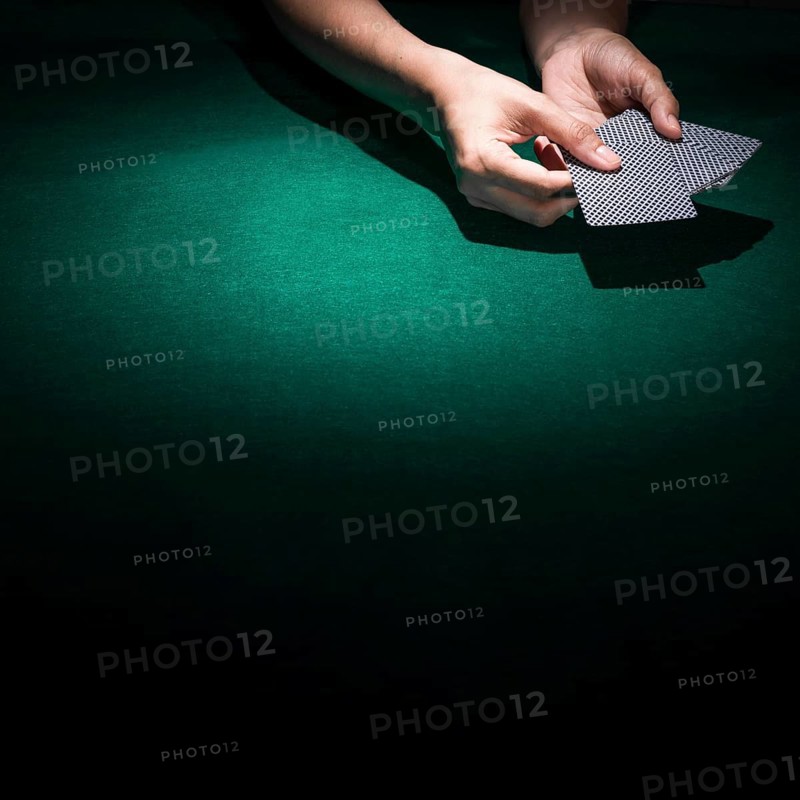 Person hand s holding poker card