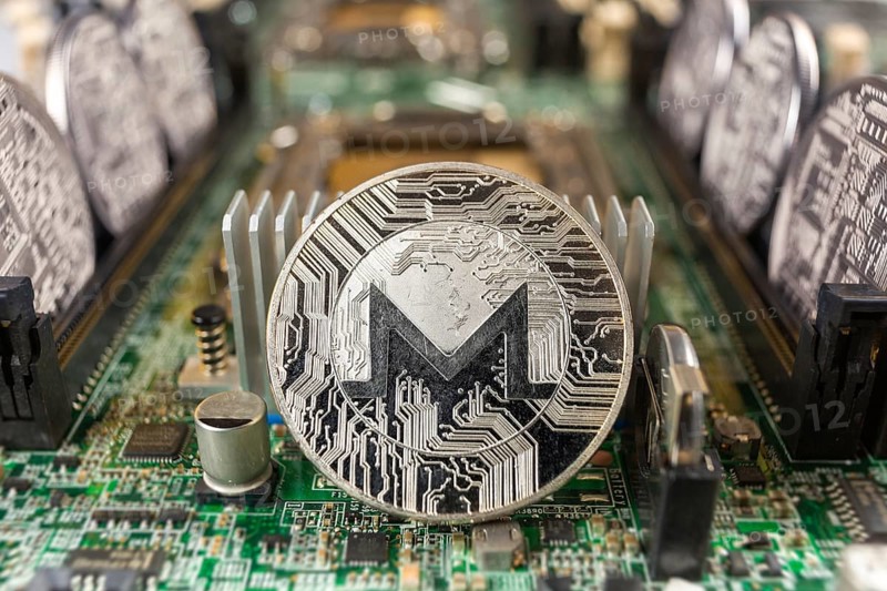 Monero coin close-up on a computer circuit motherboard as a blockchain technology payment network. Digital cryptocurrency concept and mining