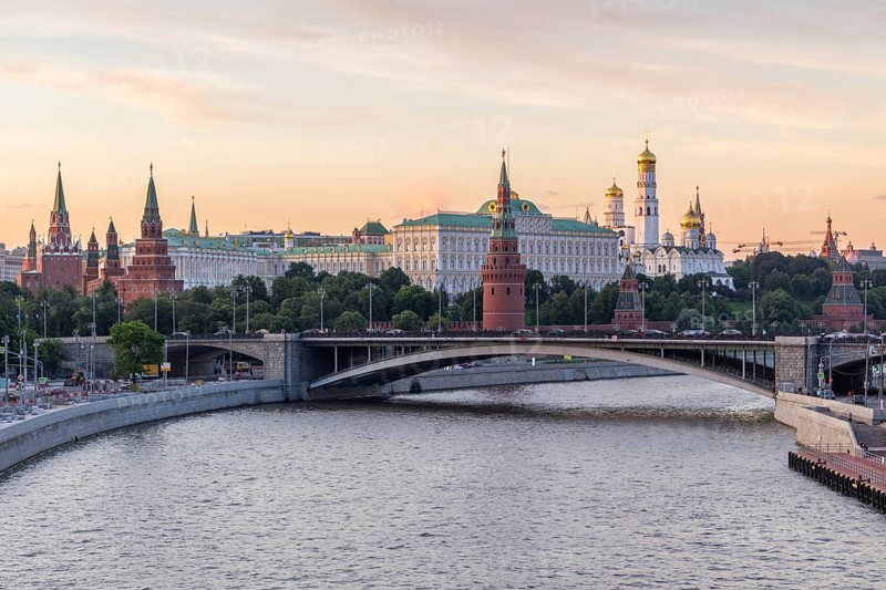 Moscow Kremlin and Moscow River in the sunny evening. Pink and golden sky. Russia