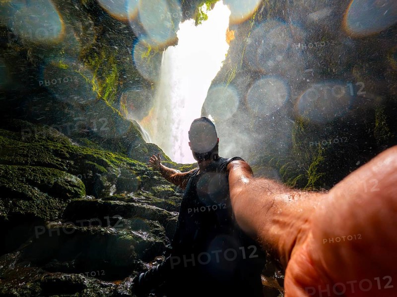 Selfie of a tourist inside the Iris grotto at the Cola de Caballo Waterfall in the Monasterio de Piedra Natural Park, Aragon