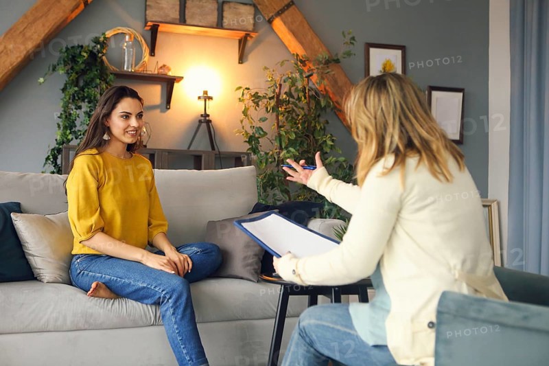 Psychologist having session with her female patient in her private consulting room