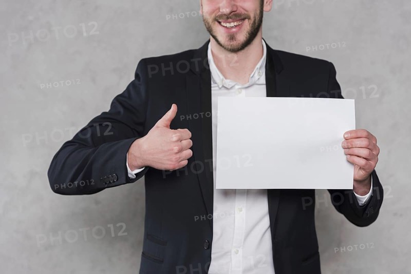 Man giving thumbs up holding blank paper