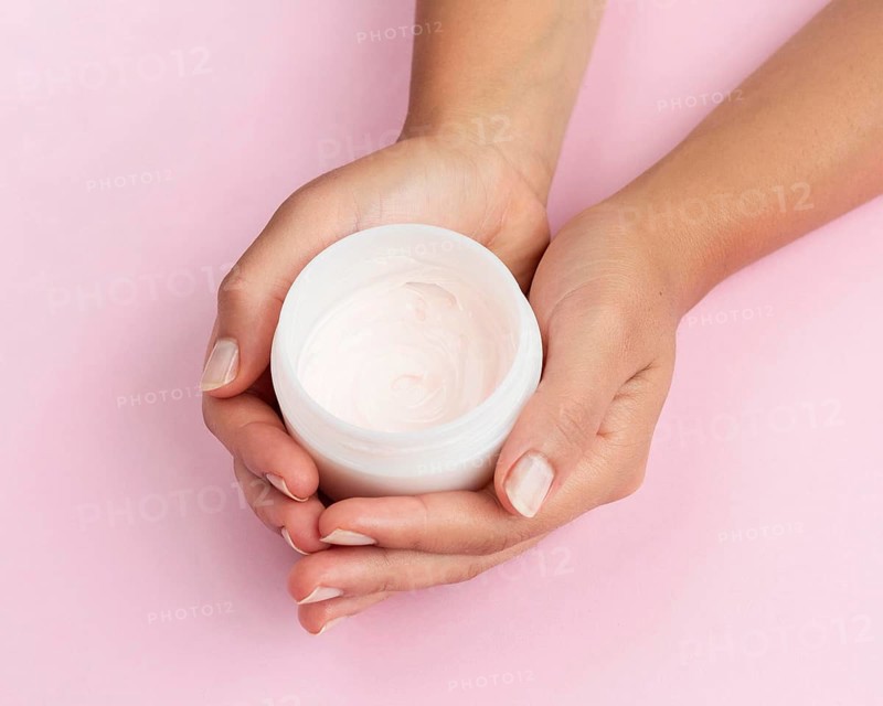 Woman holding face cream box