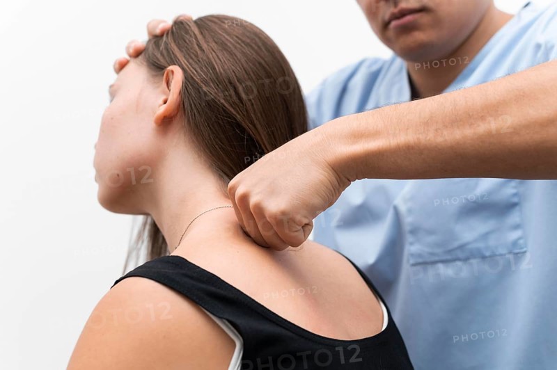 Physiotherapist massaging woman s upper back