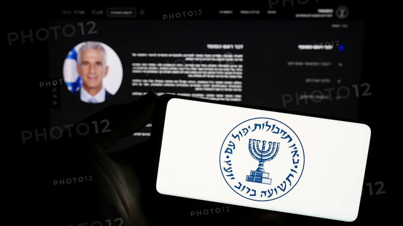 Stuttgart, Germany, 10-29-2023: Person holding smartphone with logo of Israeli national intelligence agency Mossad in front of website. Focus on phone display, Europe