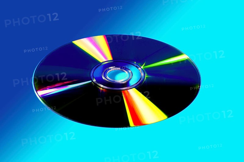 CD DVD disk with colorful reflexion over vivid blue background