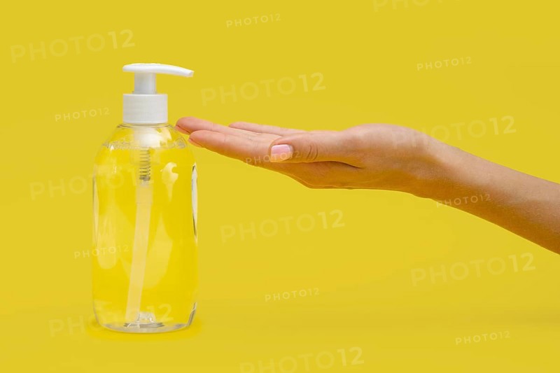 Side view hand using liquid soap