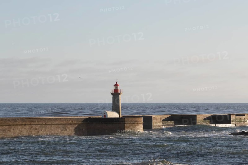 Lighthouse Farolim de Felgueiras in the Atlantic Ocean in the evening light at the beach promenade at Praia do Carneiro in Foz do Douro, Norte region, Porto district, Portugal, Europe