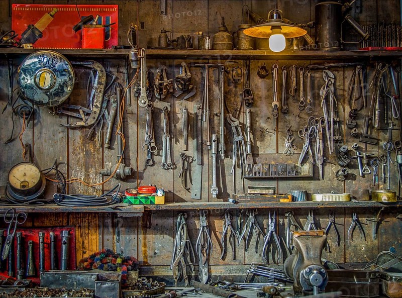 Vintage Tools Hanging On A Wall In A Tool Shed Or Workshop