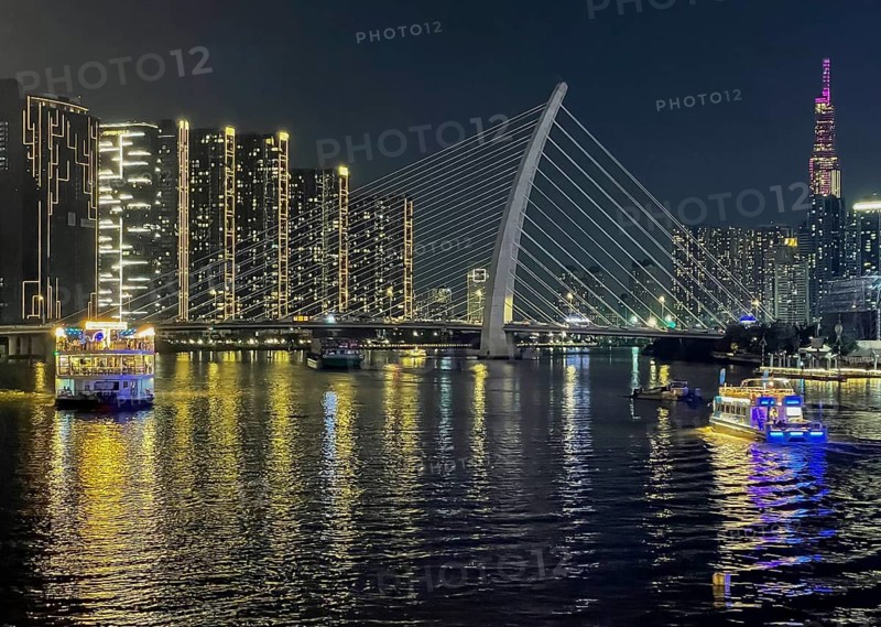 Skyline Saigon, illuminated skyscrapers and bridge Cau Ba Son over the river Song Sai Gon at night, Ho Chi Minh City, Vietnam, Asia