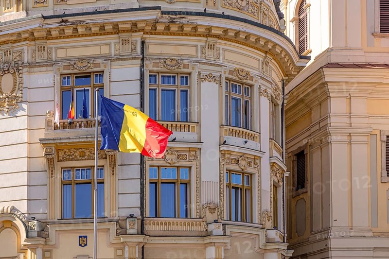 Romanian flag in front of the building that house Sibiu municipality, Sibiu, Transylvania, Romania, Europe
