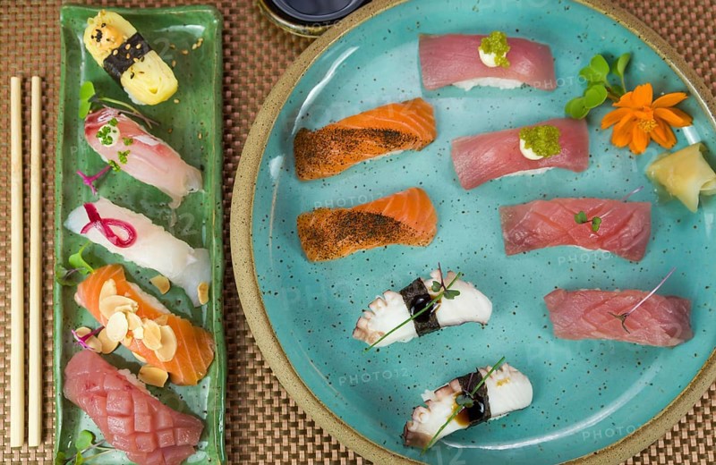Platter with different types of nigirizushi, nigiri with different fish and one decorated with a symbol of female breast cancer