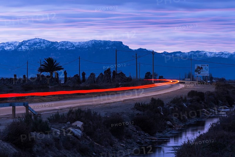Country road in the Ebro Delta, red tail lights of a car, Catalonia, Spain, Europe