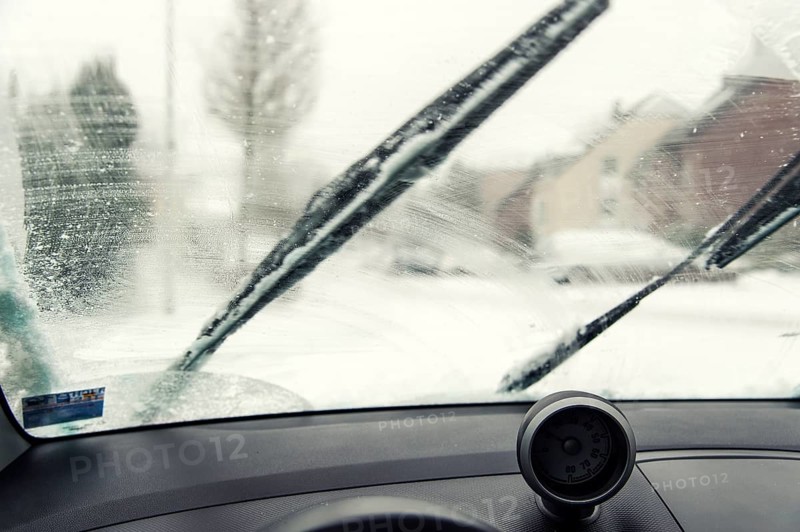 Interior view of a smudged windscreen of a car with windscreen wipers
