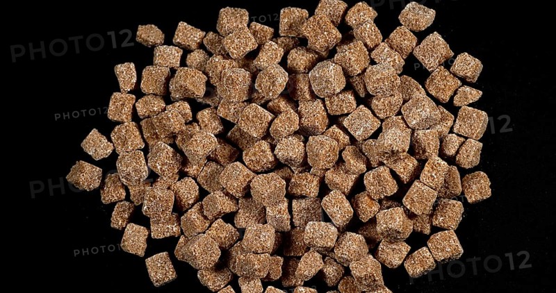 Cane Sugar falling against Black Background